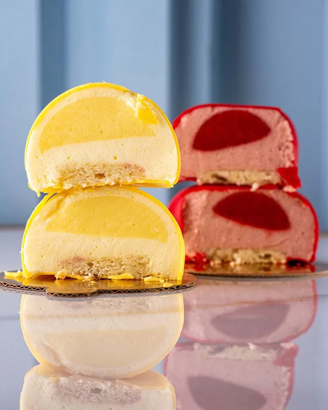 Lemon and strawberry mousse cakes, cut open
